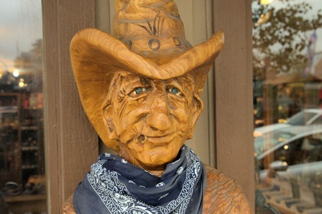 carved wood cowboy sculpture, West Yellowstone, Montana, August 20, 2014