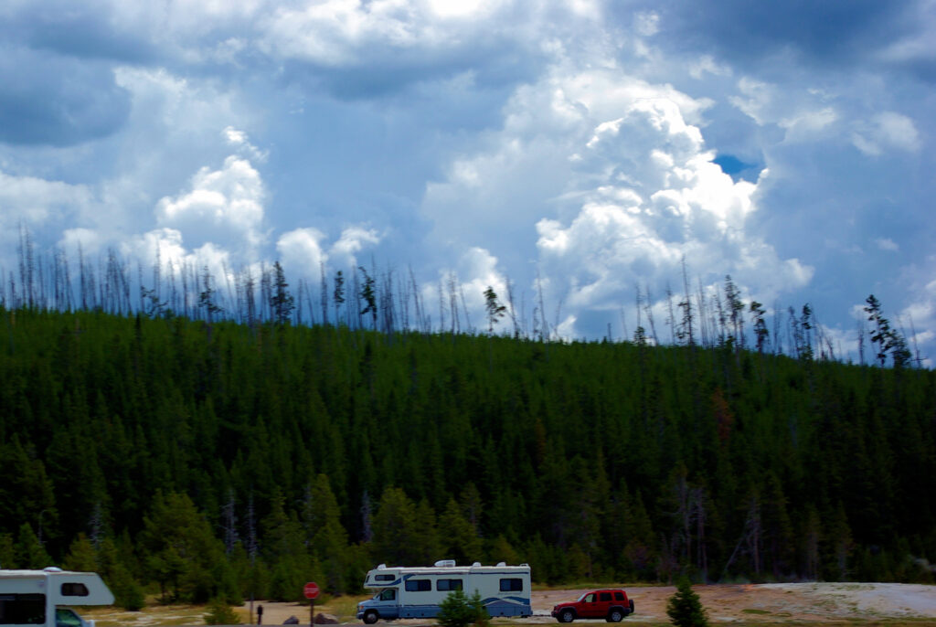 Fleetwood Jamboree Class C motorhome with a towd (towed vehicle) on Firehole Lake Drive, about 6 miles north of Old Faithful (as the crow flies)